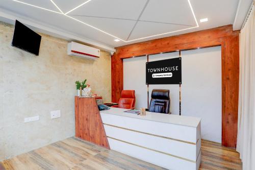 an office with a desk with a sign on the wall at Super Townhouse Sri Padmavati Ammavaari Temple Formerly Hotel Rama Grand in Tirupati