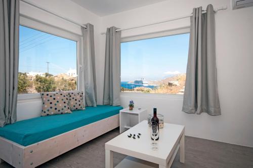 a room with a bed and a large window at Marina's House in Tourlos