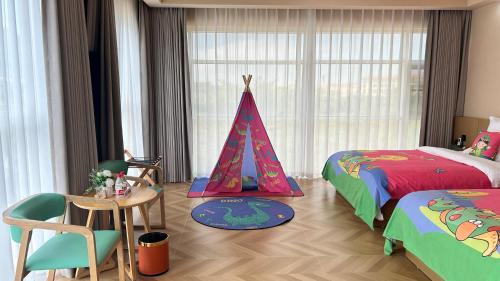 a bedroom with two beds and a tent in it at Langying Intelligent Guesthouse in Changshancun