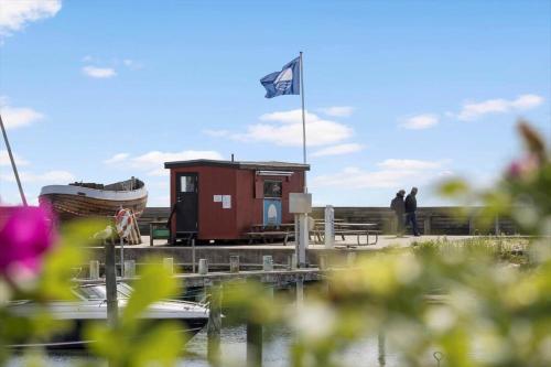a flag flying over a marina with a small shack at 20218-Samso-Rosenvej-22 in Tanderup