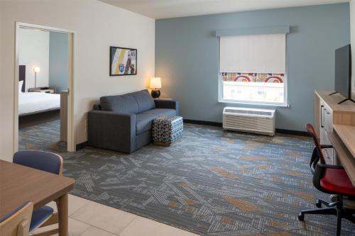 a living room with a couch and a bed and a television at Home2 Suites By Hilton West Lafayette in West Lafayette