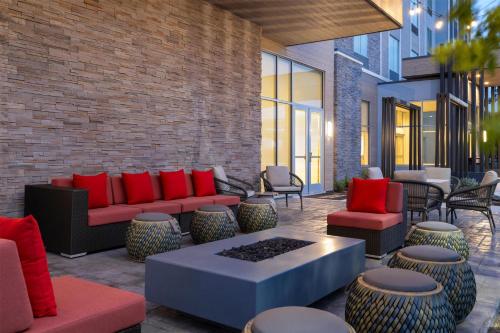 a patio with couches and tables and chairs at Hilton Garden Inn Austin Central in Austin