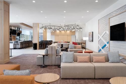 a large living room with couches and tables at Hilton Garden Inn Austin Central in Austin