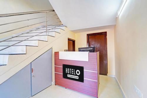 a lobby of a office with a staircase at Super Hotel O Omalloor Temple Formerly MTS Lodge in Pathanāmthitta