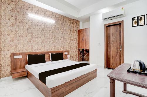 a bedroom with a large bed and a table at Collection O Palwal-Aligarh Crossway Formerly Hotel Kadamb in Palwal