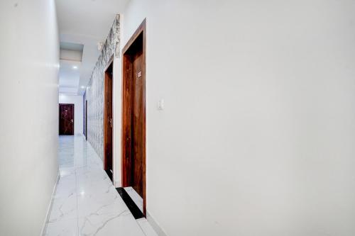 a hallway of a house with white walls at Collection O Palwal-Aligarh Crossway Formerly Hotel Kadamb in Palwal