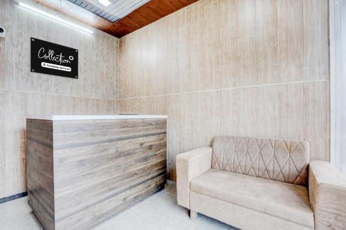 a chair in a room with a sign on the wall at Collection O Palwal-Aligarh Crossway Formerly Hotel Kadamb in Palwal