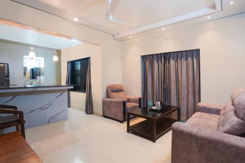 a living room with a couch and a table at Super Townhouse Oak Gravity Inn in Pune