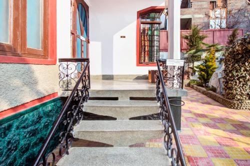 a stairway leading to a building with a swimming pool at Collection O Brein Nishat Formerly Continental Guest House in Srīnagar