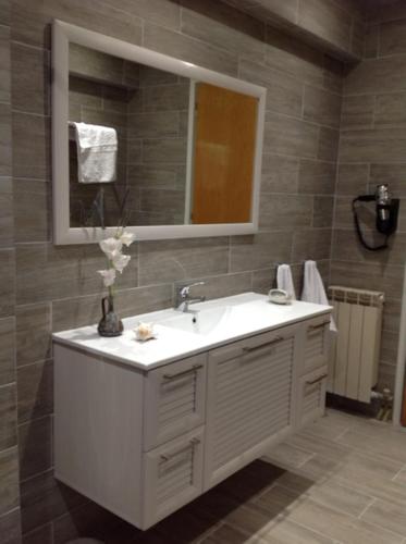a bathroom with a white sink and a mirror at Villa Leonidas in Mastichari