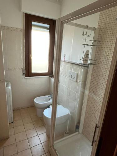 a bathroom with a toilet and a glass shower at Manuel House in Pisa in Pisa