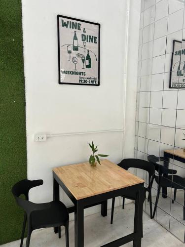 a dining room with a wooden table and chairs at PROpaganda Hostel in Koh Phangan