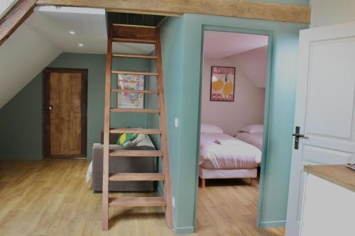 a room with a bunk bed and a ladder at La Bullote - Gîtes - Paris Roissy CDG in Villeneuve-sous-Dammartin