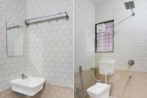 a white bathroom with a toilet and a sink at Super Townhouse Hinjewadi Corporate Stays in Pune