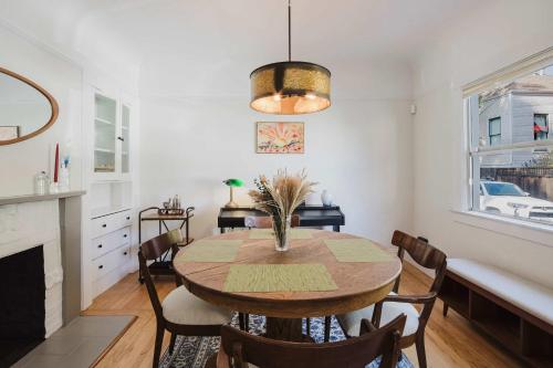 a dining room with a wooden table and chairs at Allura Oakland Your Private Sanctuary in the City in Oakland