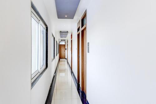 an empty corridor in a hospital with windows at Super Townhouse Zero Mile Gandhi Setu Formerly Classic Court in Gulzārbāgh