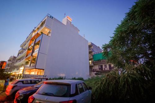 a building with cars parked in front of it at Hotel Maharaja Palace Boutique Hotels Near Medanta Medicity Gurgaon in Gurgaon