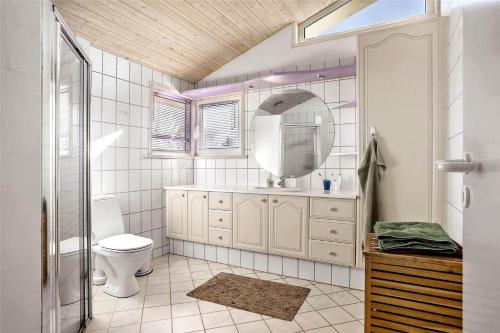 a bathroom with a toilet and a mirror at TV1383-Hirtshals-Klitmarken-14 in Hirtshals