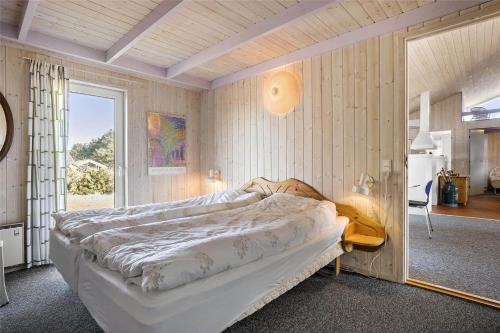 a bedroom with a large bed in a room at TV1383-Hirtshals-Klitmarken-14 in Hirtshals
