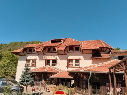 a large house with red tile roofs at Etno selo Srna in Kalna
