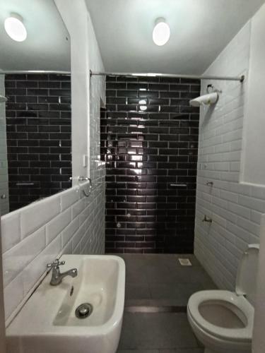 a bathroom with a sink and a toilet at Luxe Studio Kinoo in Rungiri