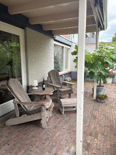 a patio with two chairs and a table on a house at bb-jonashome in Venlo