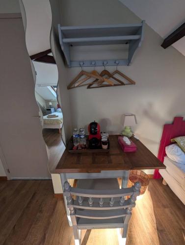 a room with a table in a room with a bed at Gîtes chez julie in Beaucamps-Ligny
