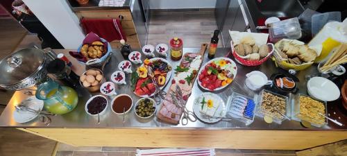 a table topped with lots of different types of food at Tweet Apartments with Sauna and optional Breakfast Close To Terme Sveti Martin in Štrigova