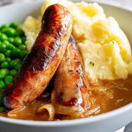 a bowl of food with sausage and potatoes and peas at The Shamrock in Bang Sare