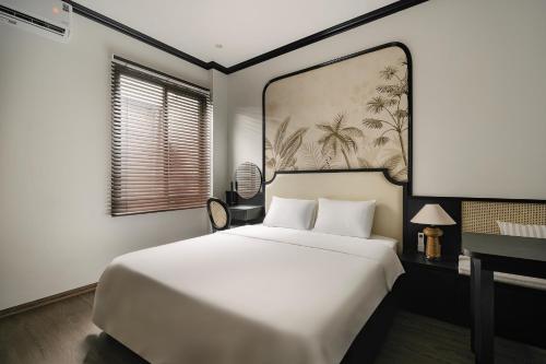 a bedroom with a large white bed and a window at Dom's Residence Hoan Kiem in Hanoi