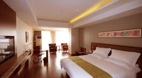 a hotel room with a bed and a living room at Yitel Collection Lianyungang High-speed Railway Station Suning Plaza in Lianyungang