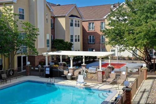 a swimming pool with a gazebo next to a building at Homewood Suites by Hilton Kansas City Airport in Kansas City