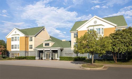 a rendering of a large house with green roofs at Homewood Suites by Hilton Dulles-North Loudoun in Ashburn