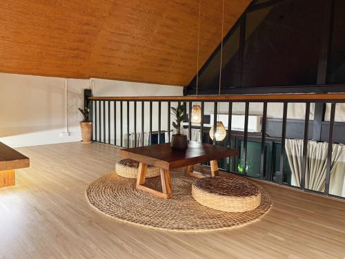 a living room with a table and a rug at GoldenHour House- Seaview & Sunset in Koh Phangan