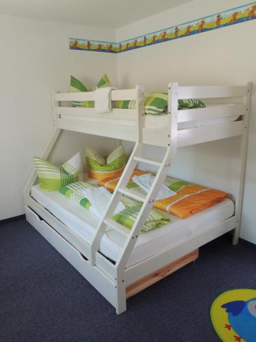 two bunk beds in a room with a ladder at Hotel Faxe Schwarzwälder Hof in Kappelrodeck