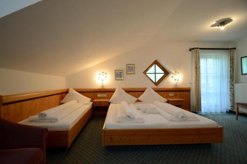 a hotel room with two beds in it at Appartements Baumanngut in Wagrain