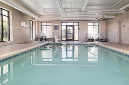 a swimming pool with blue water in a building at Homewood Suites By Hilton Wauwatosa Milwaukee in Wauwatosa