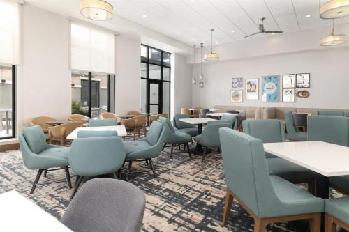 a waiting room at a restaurant with tables and chairs at Homewood Suites By Hilton Wauwatosa Milwaukee in Wauwatosa