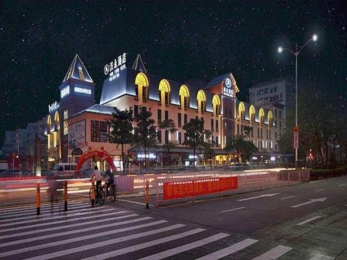a building on a city street at night at Hanyong Hotel Shenzhen International Exhibition Center in Shenzhen