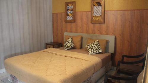 a bedroom with a bed with two pillows on it at Candra Dewi Yogyakarta in Timuran