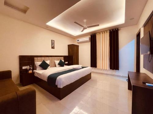 a hotel room with a bed and a couch at Hotel The Divine Ganga - Top Rated !! Most Awarded !! Budget Friendly !! Couple Friendly !! Parking !! Lift in Haridwār