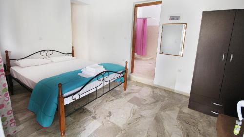a bedroom with a bed and a dresser and a mirror at Ampelos apartment and studios in Xerokampos