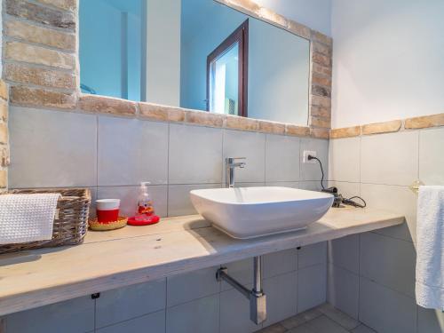 a bathroom with a white sink and a mirror at Ollastu Apartments Villasimius in Villasimius