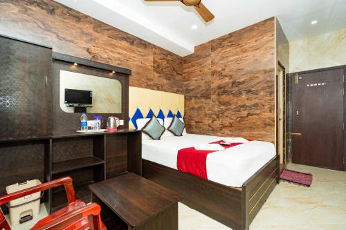 a hotel room with a bed and a tv at RCH Hotels in Rāmeswaram