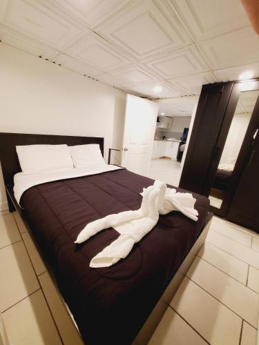 a white robe laying on a bed in a room at Nice 3BR Apt | 3 Beds |15 Min to NYC/Manhattan! in North Bergen