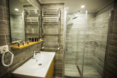 a bathroom with a sink and a shower at Doa Suite Hotel in Trabzon