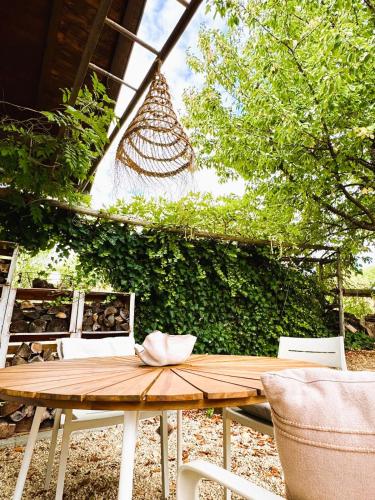 a wooden table with a bow on top of it at Weinloft I by WEINLOFTS in Edlitz im Burgenland