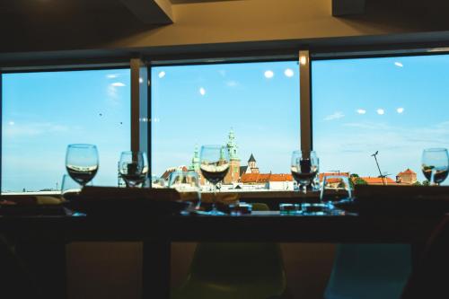 a group of glasses sitting on a table in front of a window at Aparthotel Best Views in Krakow