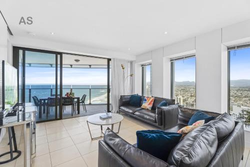 a living room with leather furniture and a view of the ocean at Soul - Private Apartments - Apartment Stay in Gold Coast