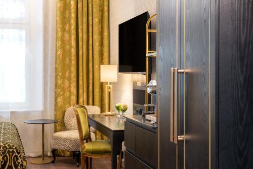 a kitchen with a desk and a refrigerator at Thon Hotel Vasa in Stockholm